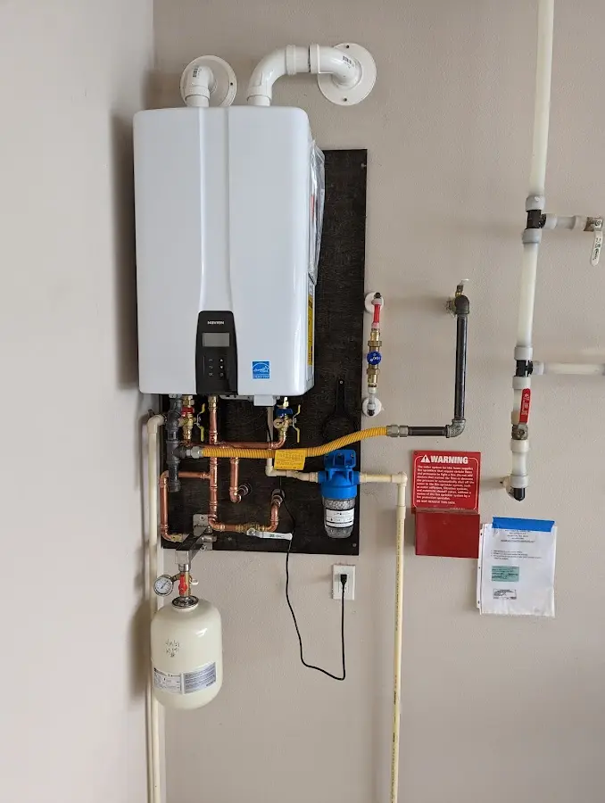 Professional plumber installing copper piping in a Triana home